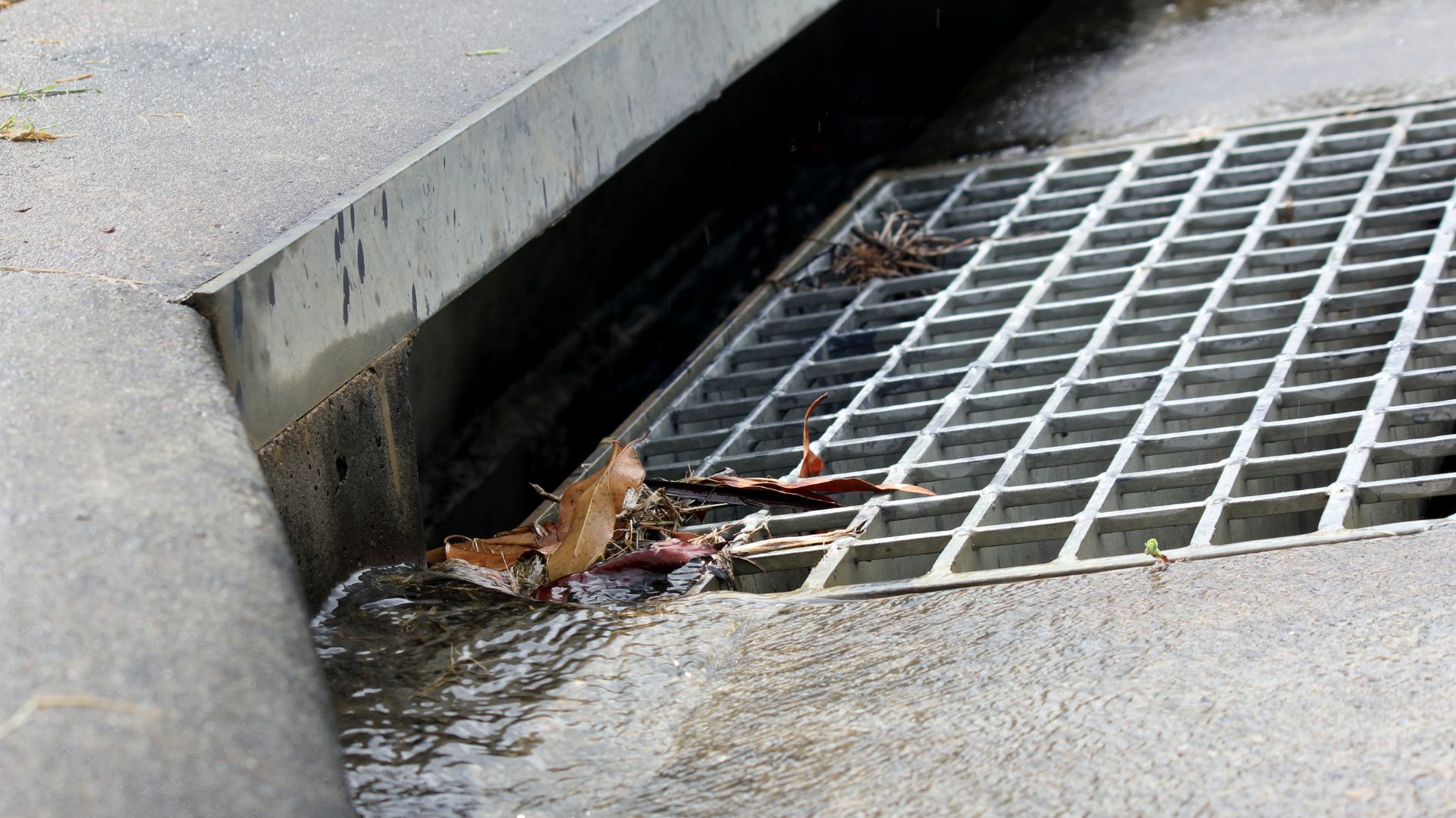 a storm drain on a public sidewalk